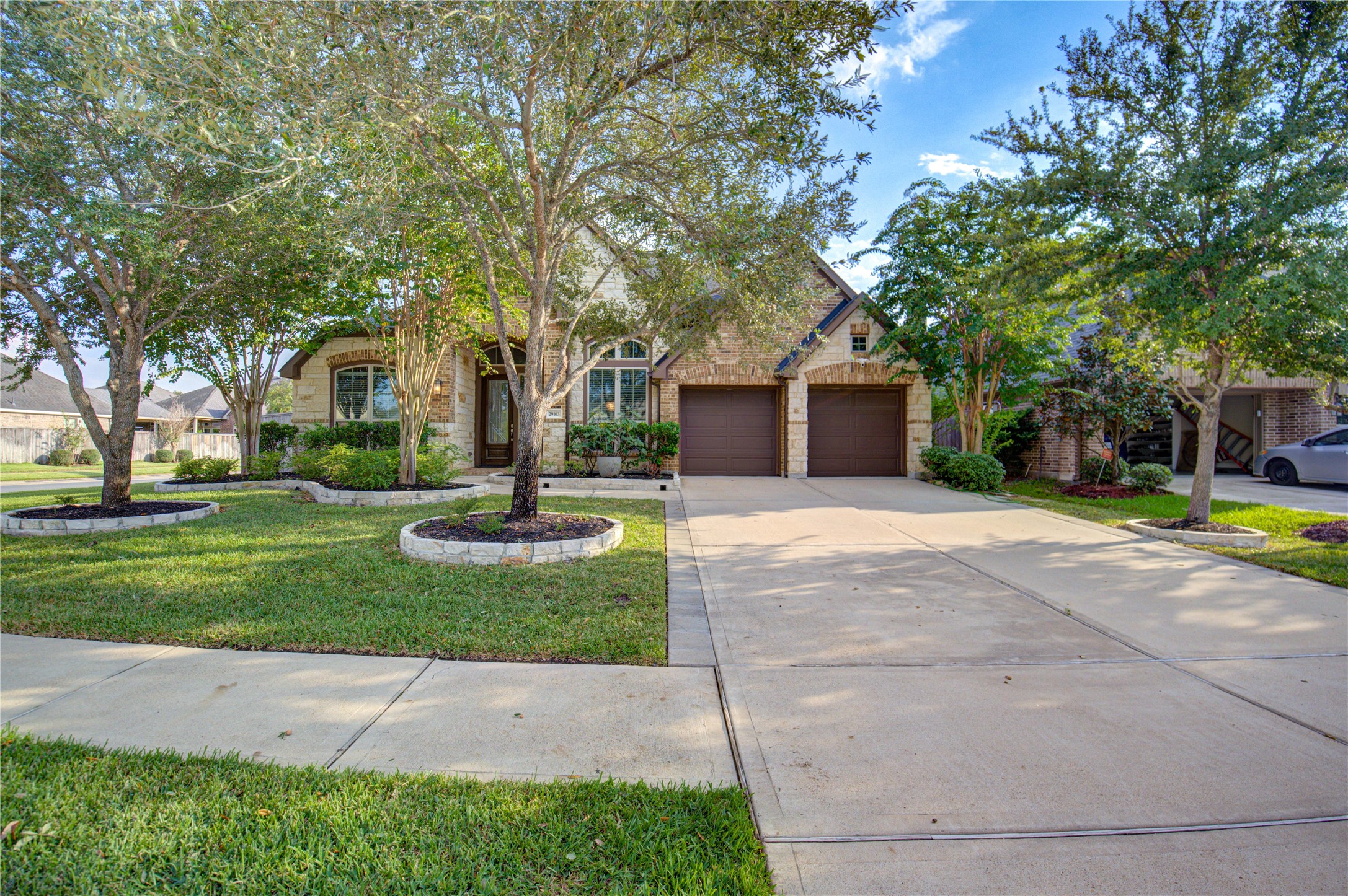 29103 Erica Lee Court Katy, TX 77494 - Photo 3 of 49 a front view of a house with garden and trees