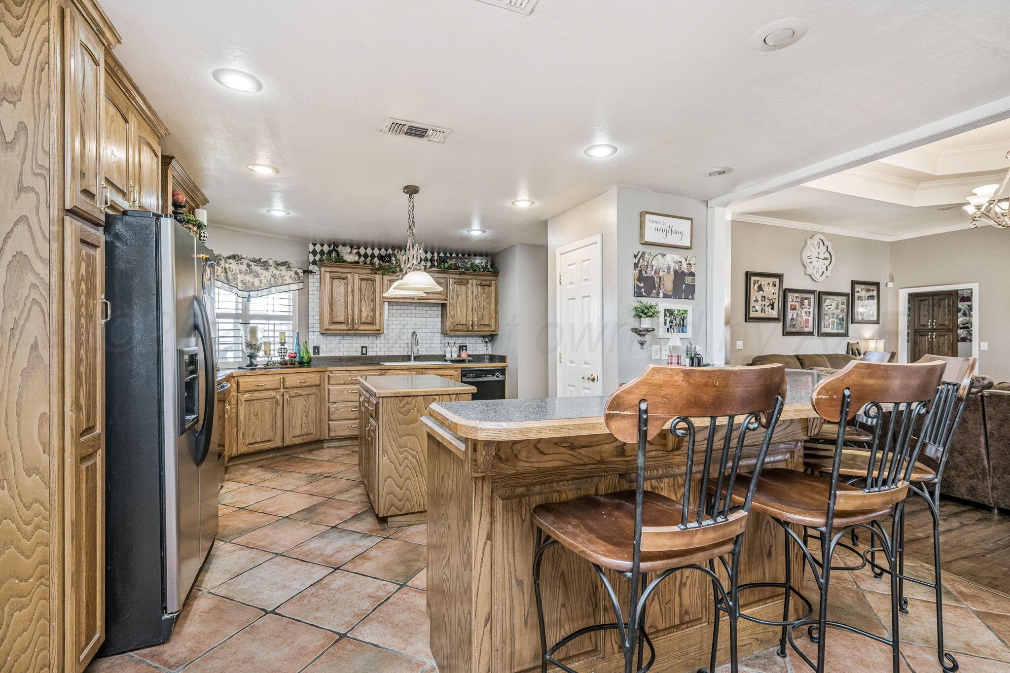 200 Hunters Trail Amarillo, TX 79124 - Photo 6 of 23 a kitchen with a table and chairs