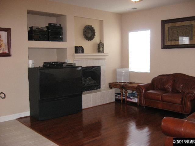 10661 Copper Moon Court Reno, NV 89521 - Photo 3 of 9 a living room with furniture a fireplace and a window