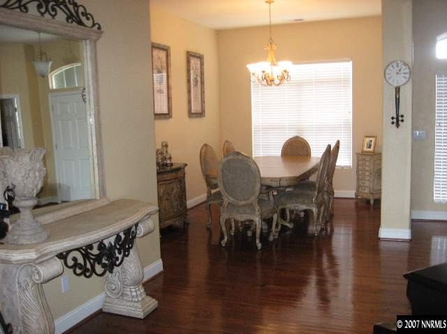10661 Copper Moon Court Reno, NV 89521 - Photo 6 of 9 a dining room with chandelier fan and wooden floor