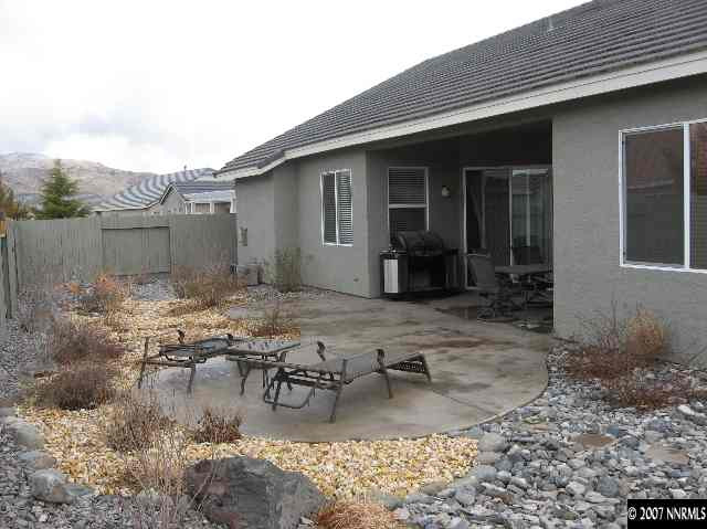 10661 Copper Moon Court Reno, NV 89521 - Photo 9 of 9 a backyard of a house with yard fire pit and outdoor seating