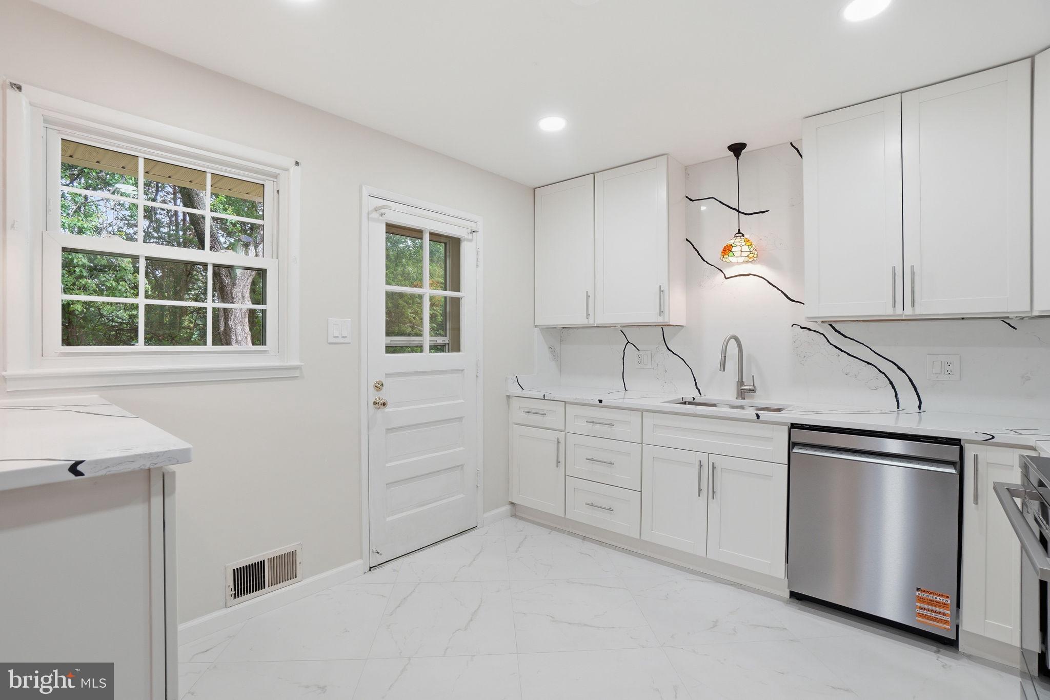 5304 Pillow Lane Springfield, VA 22151 - Photo 4 of 32 a kitchen with white cabinets and window