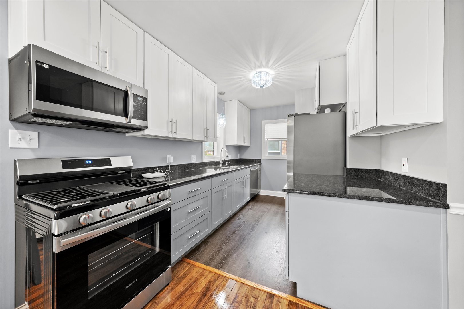 12223 South Ada Street Chicago, IL 60643 - Photo 5 of 22 a kitchen with stainless steel appliances a stove a microwave and white cabinets