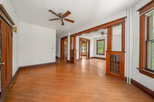 wooden floor in an empty room with a window