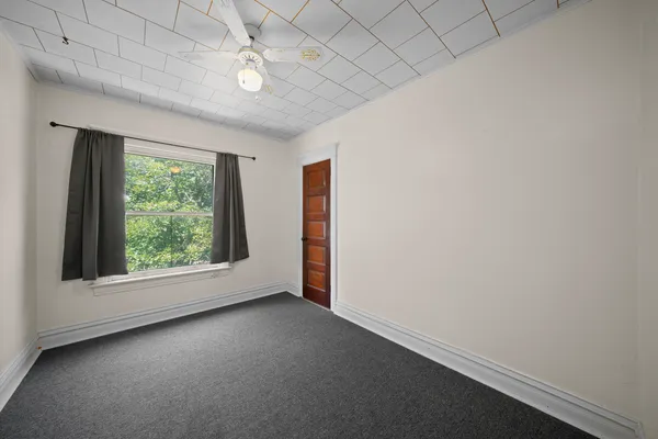an empty room with windows and closet