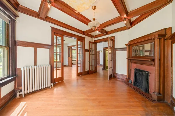 a view of livingroom with furniture wooden floor fire place and windows