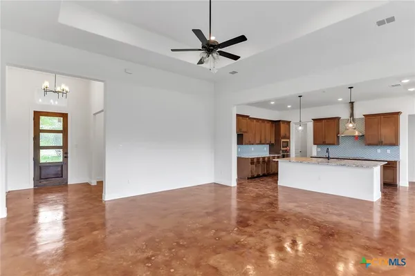 a view of a livingroom with a kitchen and a stove top oven