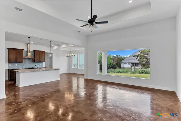 a view of a kitchen with microwave and floor to ceiling window