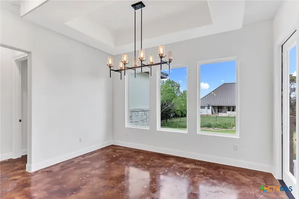 a view of a room with a window and chandelier