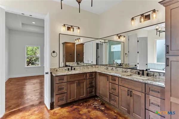 a spacious bathroom with a sink and a mirror