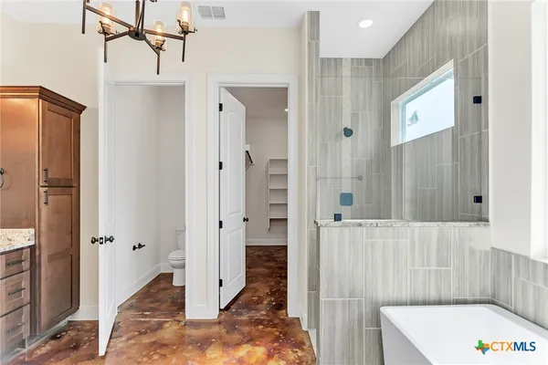 a bathroom with a tub and shower