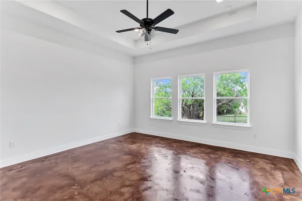 a view of a room with a window and a fan
