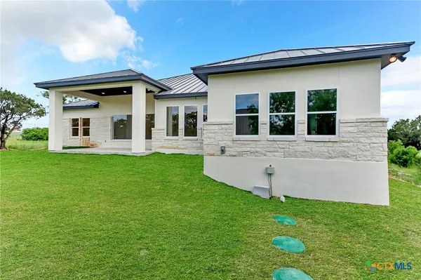 a front view of house with yard and green space