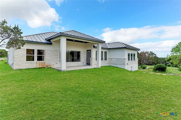 a front view of house with yard and green space