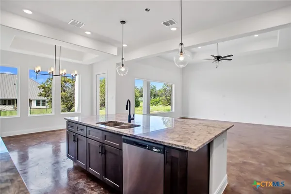 a kitchen with center island and windows