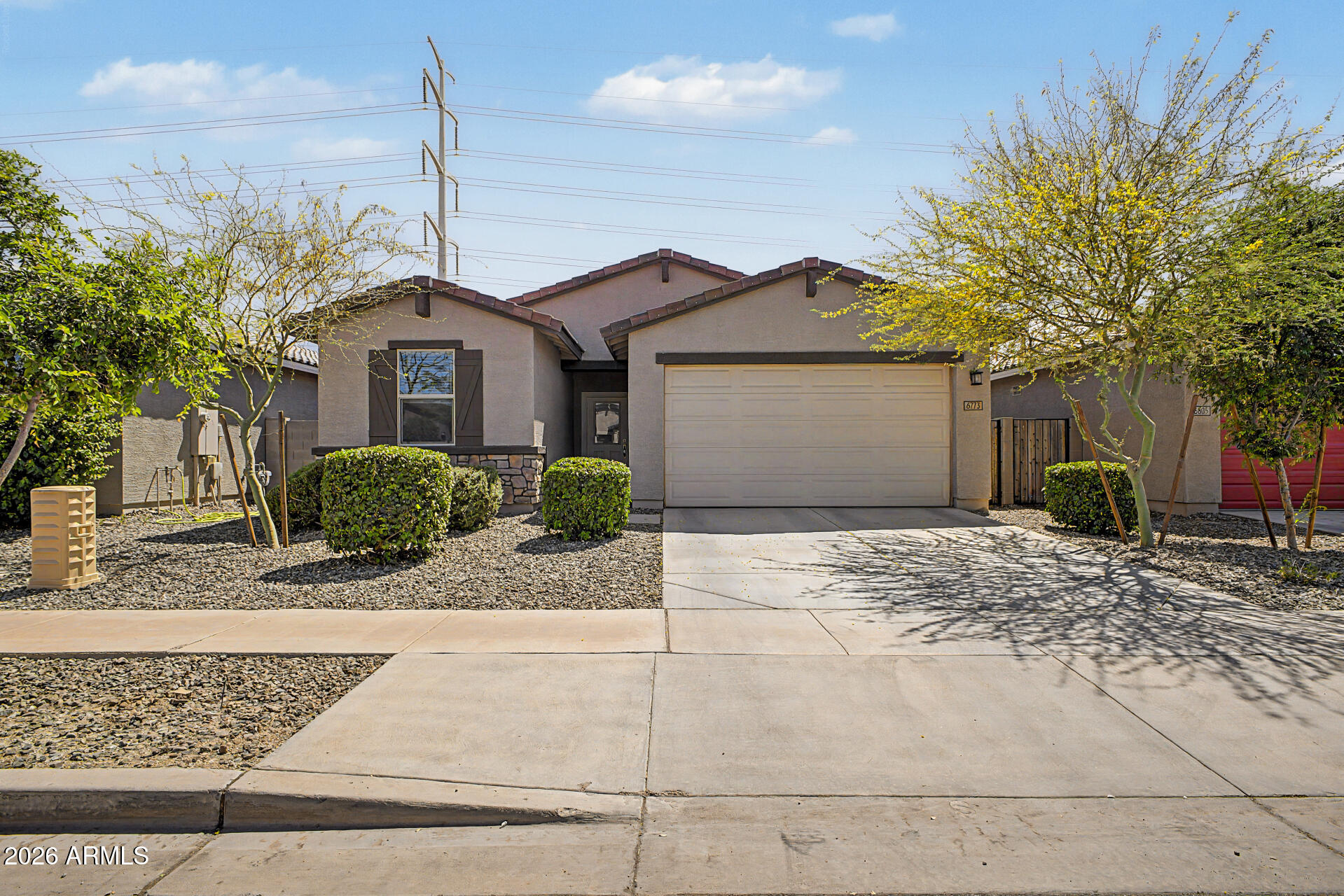 6773 West Trumbull Road Phoenix, AZ 85043 - Photo 1 of 30 a front view of a house with a yard