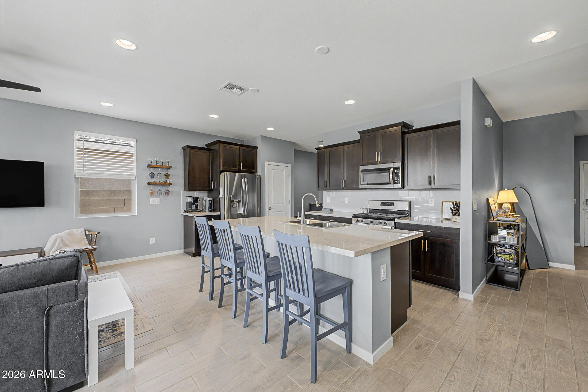 6773 West Trumbull Road Phoenix, AZ 85043 - Photo 10 of 30 a kitchen with a sink a stove a refrigerator cabinets and a dining table