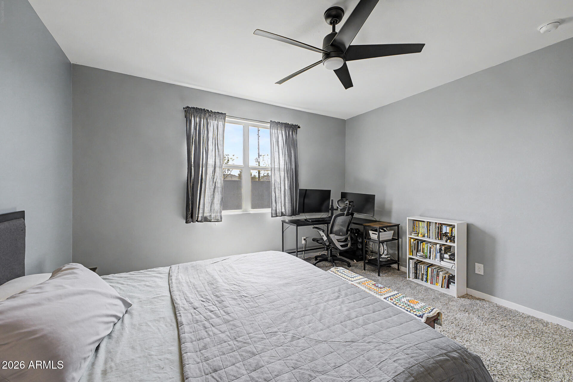 6773 West Trumbull Road Phoenix, AZ 85043 - Photo 15 of 30 a bedroom with a bed and a window