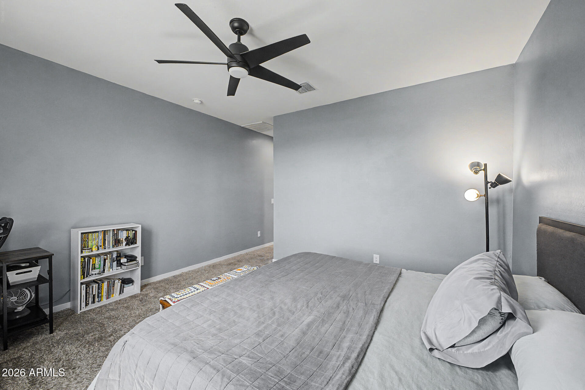 6773 West Trumbull Road Phoenix, AZ 85043 - Photo 16 of 30 a bedroom with a bed and a painting on the wall