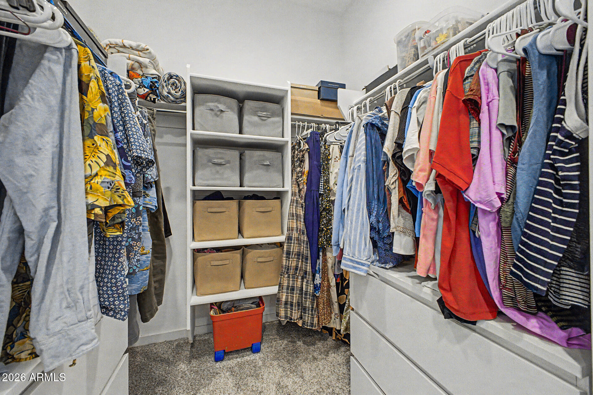 6773 West Trumbull Road Phoenix, AZ 85043 - Photo 18 of 30 a view of walk in closet with clothes and shoes