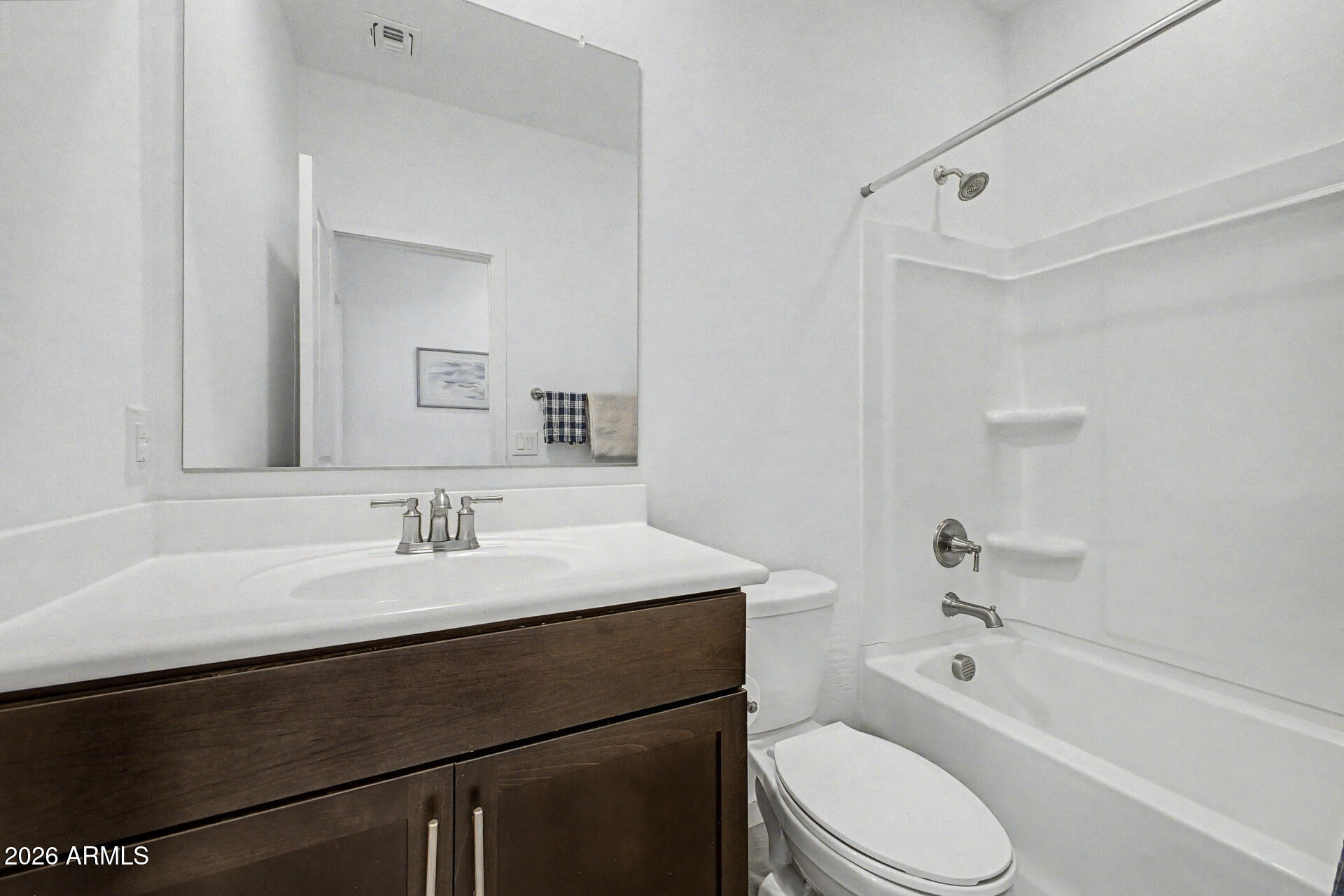 6773 West Trumbull Road Phoenix, AZ 85043 - Photo 21 of 30 a bathroom with a granite countertop sink toilet a mirror and bathtub