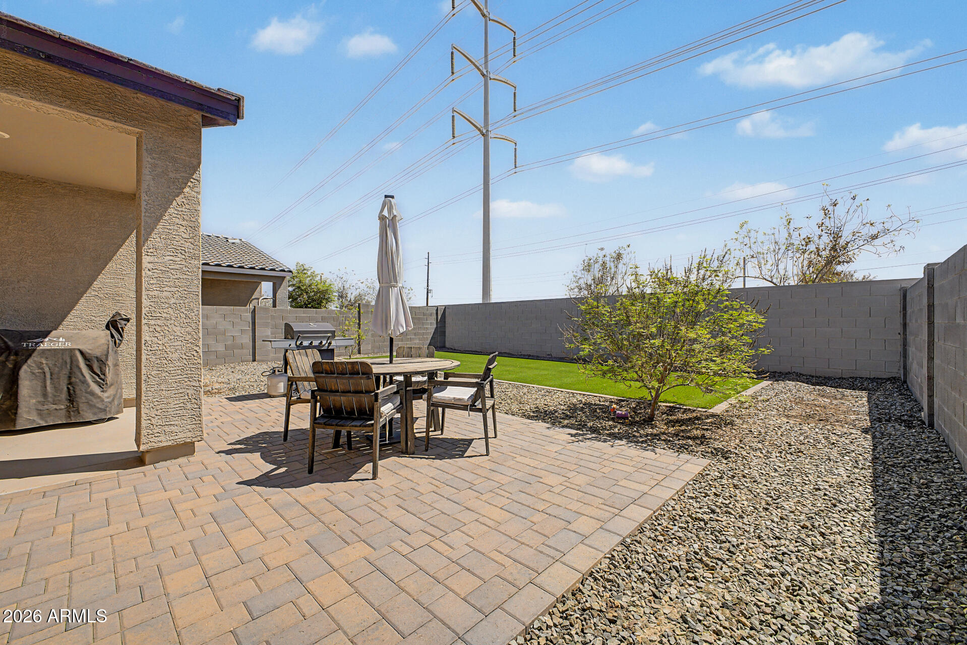 6773 West Trumbull Road Phoenix, AZ 85043 - Photo 25 of 30 a view of a patio with a table and chairs