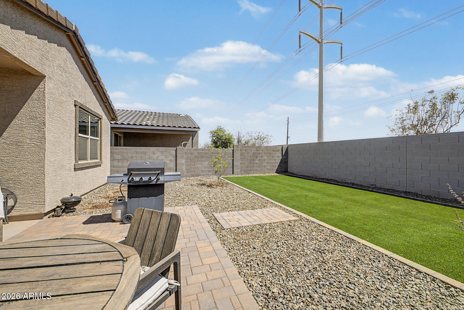 6773 West Trumbull Road Phoenix, AZ 85043 - Photo 27 of 30 a view of a patio with a table chairs and a grill