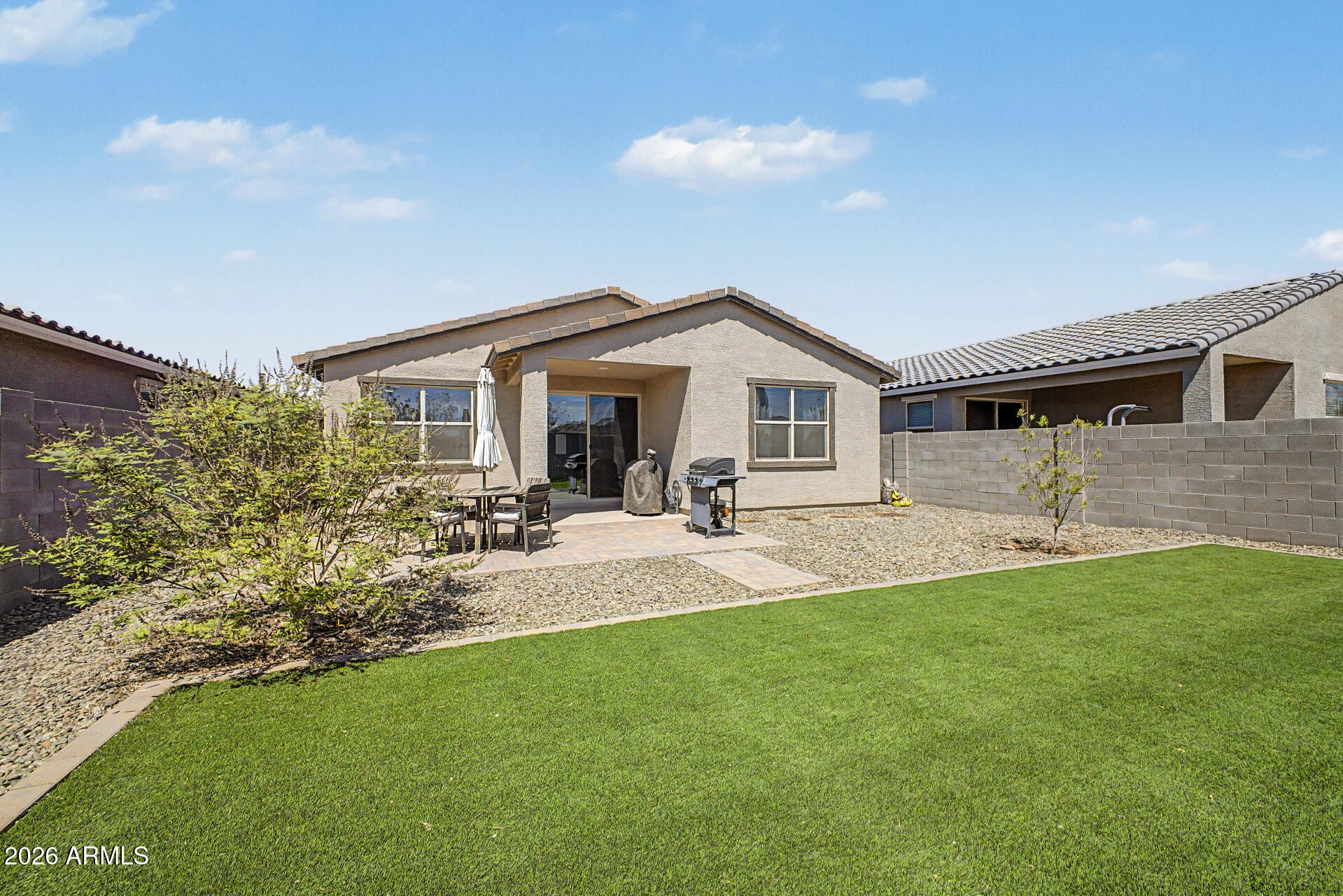 6773 West Trumbull Road Phoenix, AZ 85043 - Photo 28 of 30 a front view of a house with a yard and porch