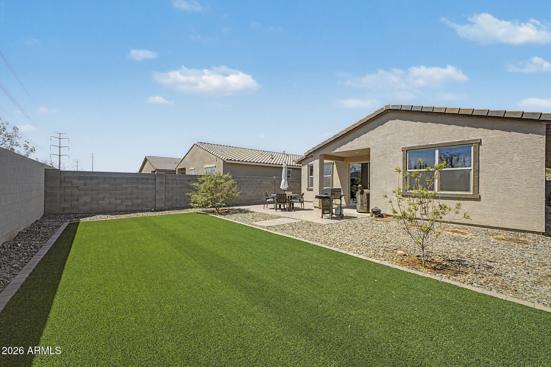 6773 West Trumbull Road Phoenix, AZ 85043 - Photo 29 of 30 a backyard of a house with table and chairs