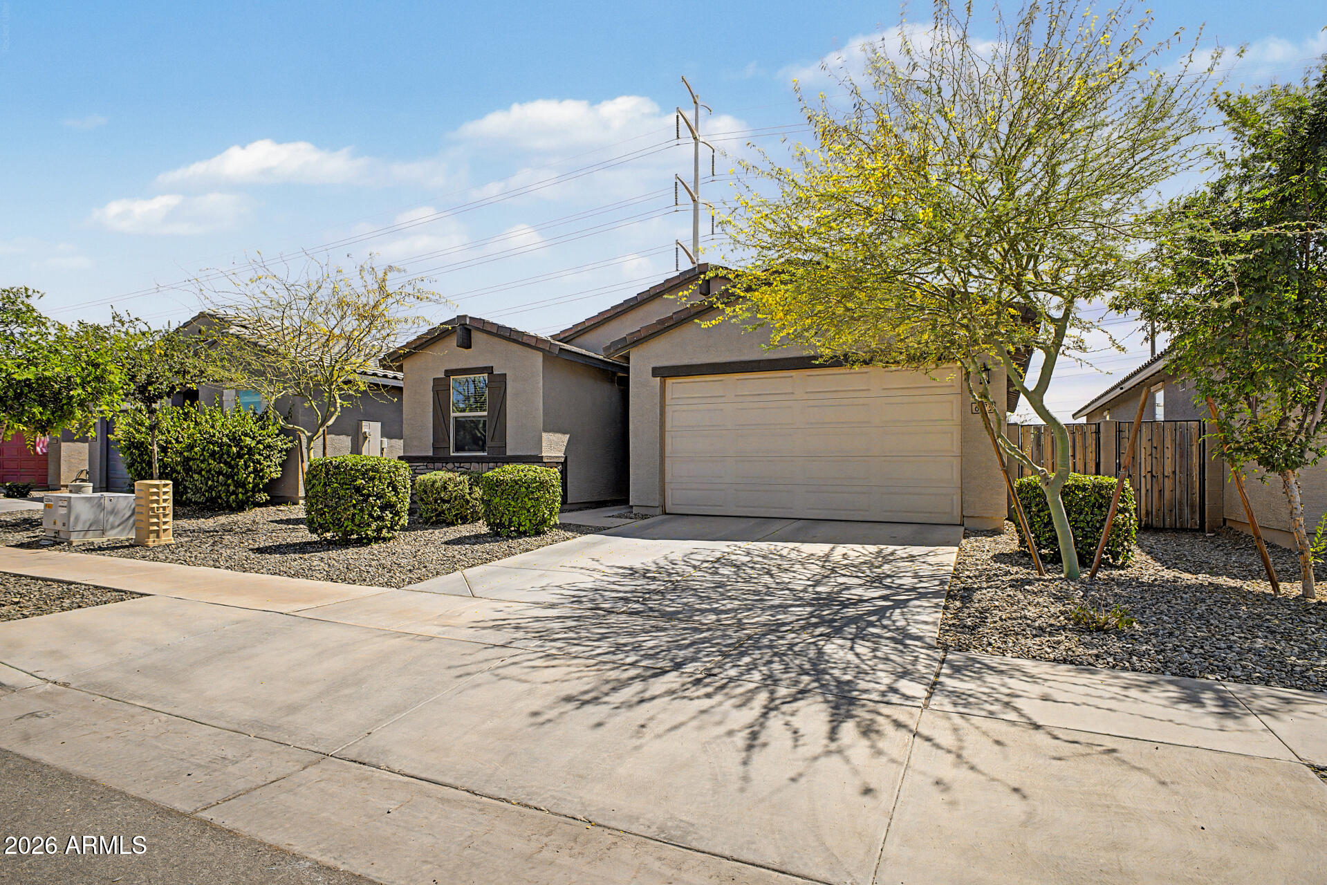 6773 West Trumbull Road Phoenix, AZ 85043 - Photo 3 of 30 a front view of a house with a yard and garage