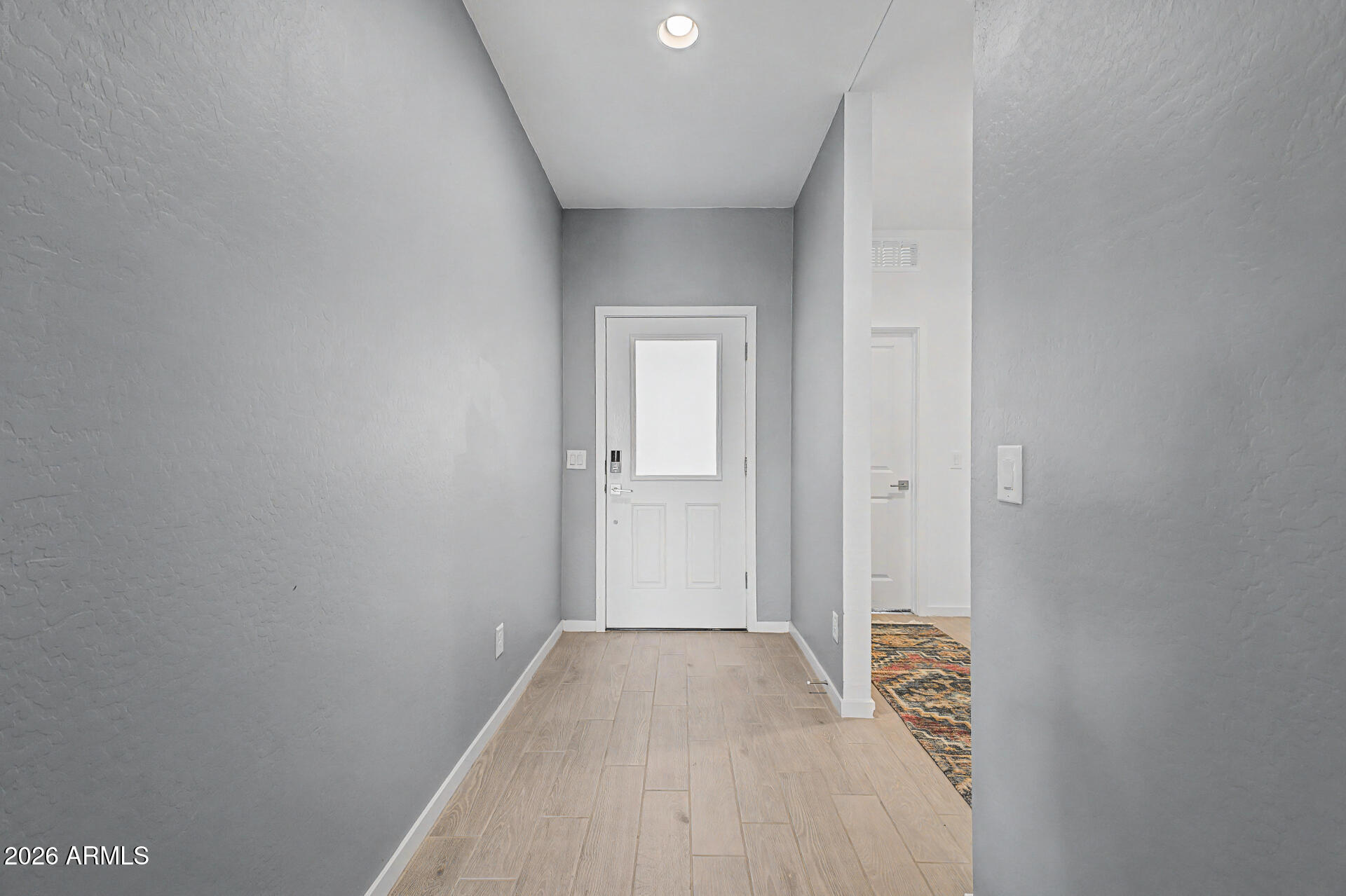 6773 West Trumbull Road Phoenix, AZ 85043 - Photo 4 of 30 a view of a livingroom with wooden floor and a bathroom