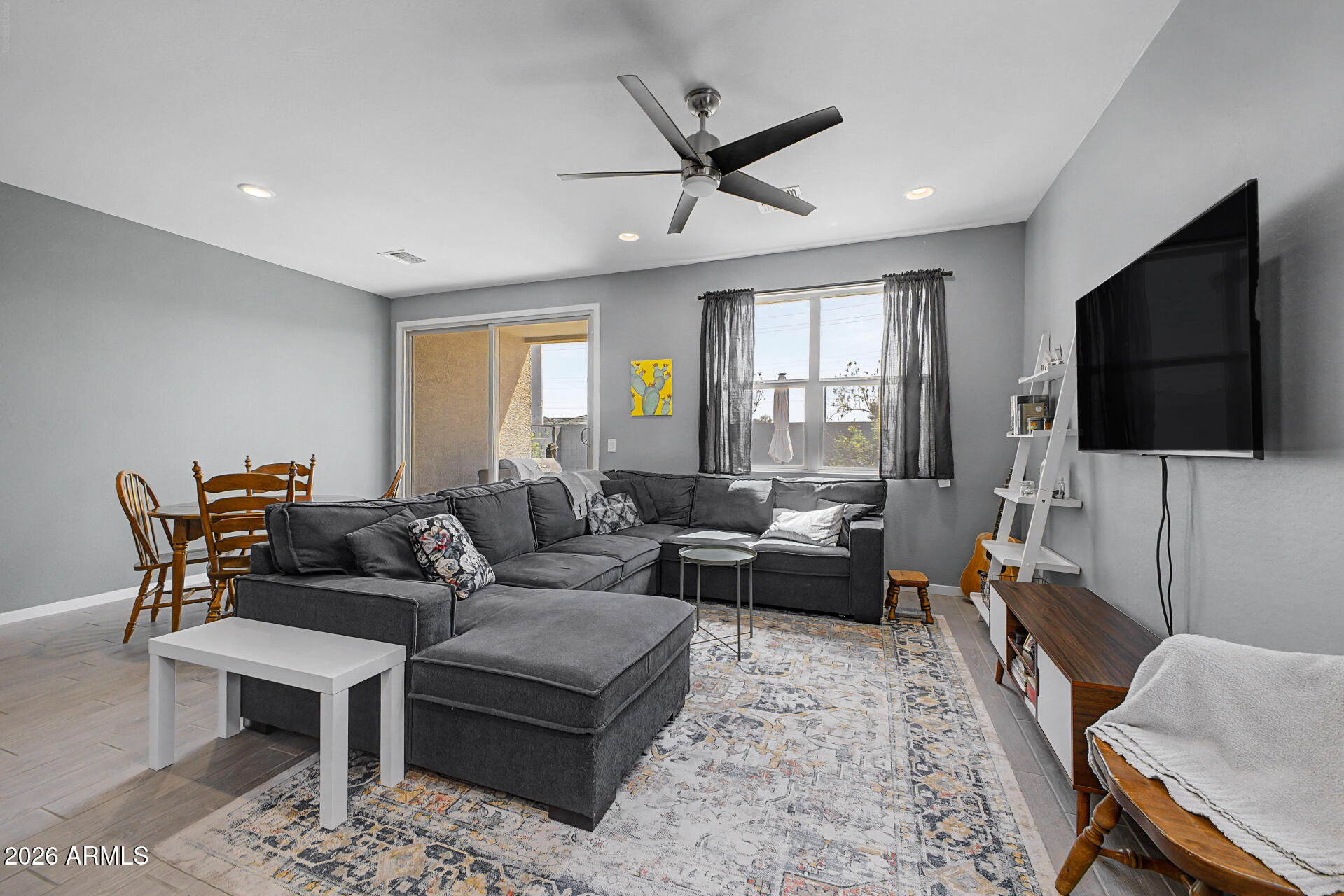 6773 West Trumbull Road Phoenix, AZ 85043 - Photo 5 of 30 a living room with furniture and a flat screen tv