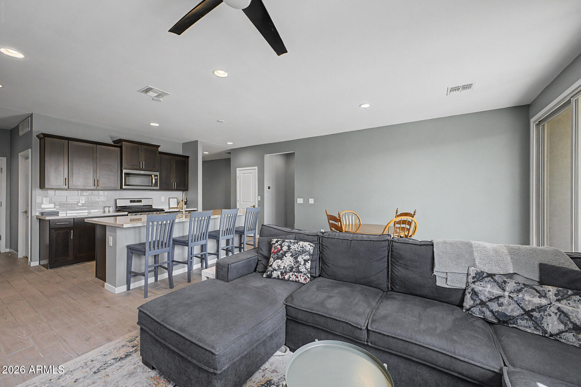 6773 West Trumbull Road Phoenix, AZ 85043 - Photo 6 of 30 a living room with furniture and kitchen