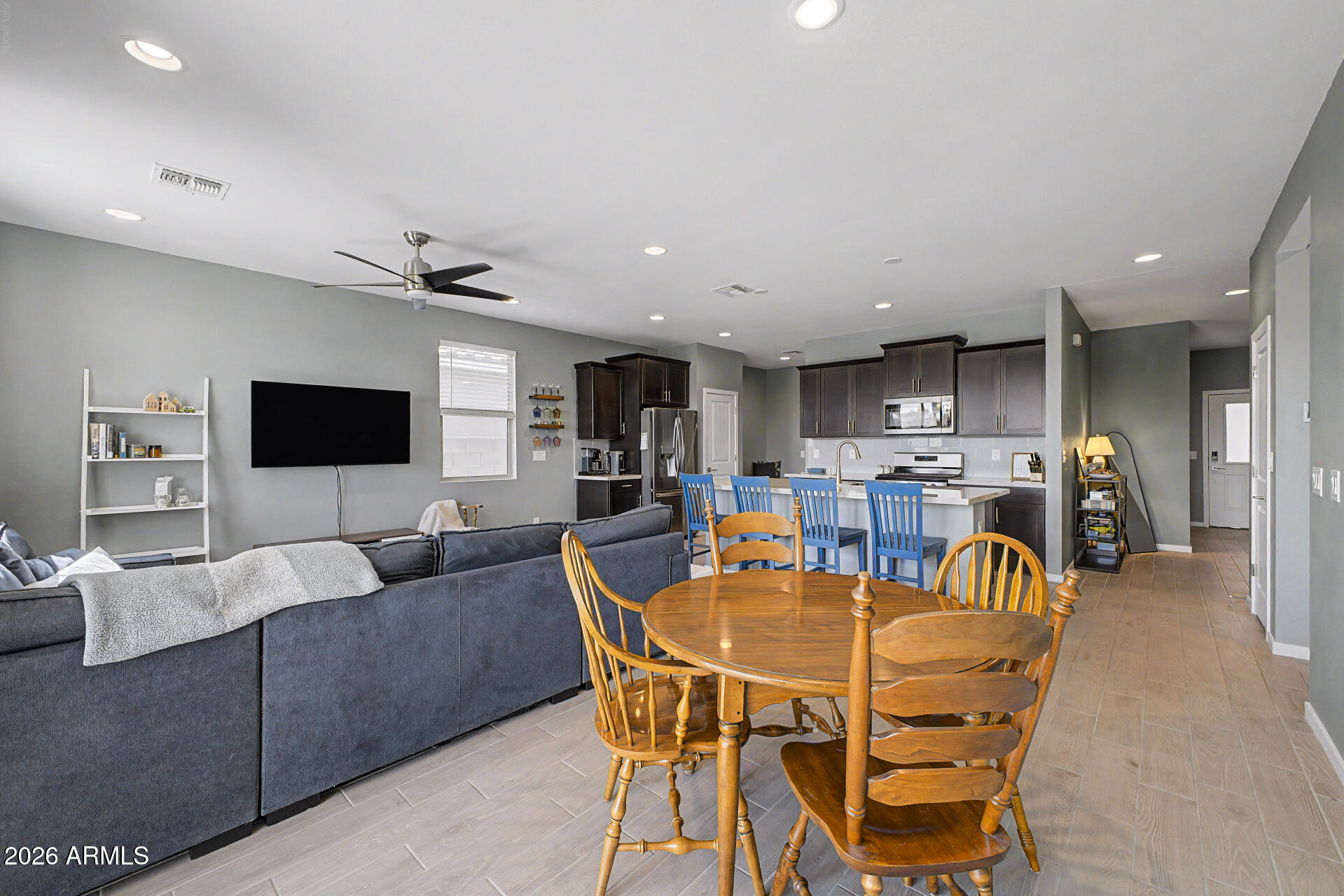 6773 West Trumbull Road Phoenix, AZ 85043 - Photo 7 of 30 a living room with furniture and a flat screen tv
