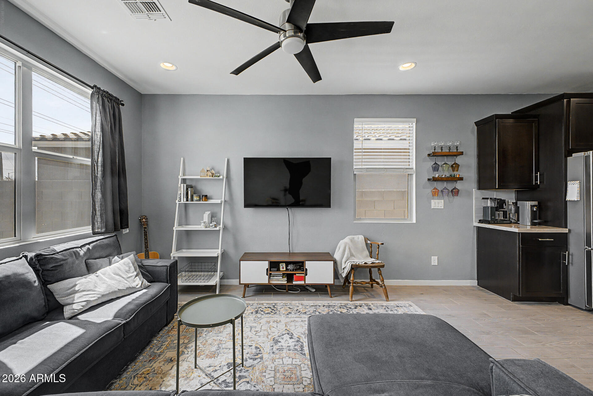 6773 West Trumbull Road Phoenix, AZ 85043 - Photo 8 of 30 a living room with furniture and a flat screen tv