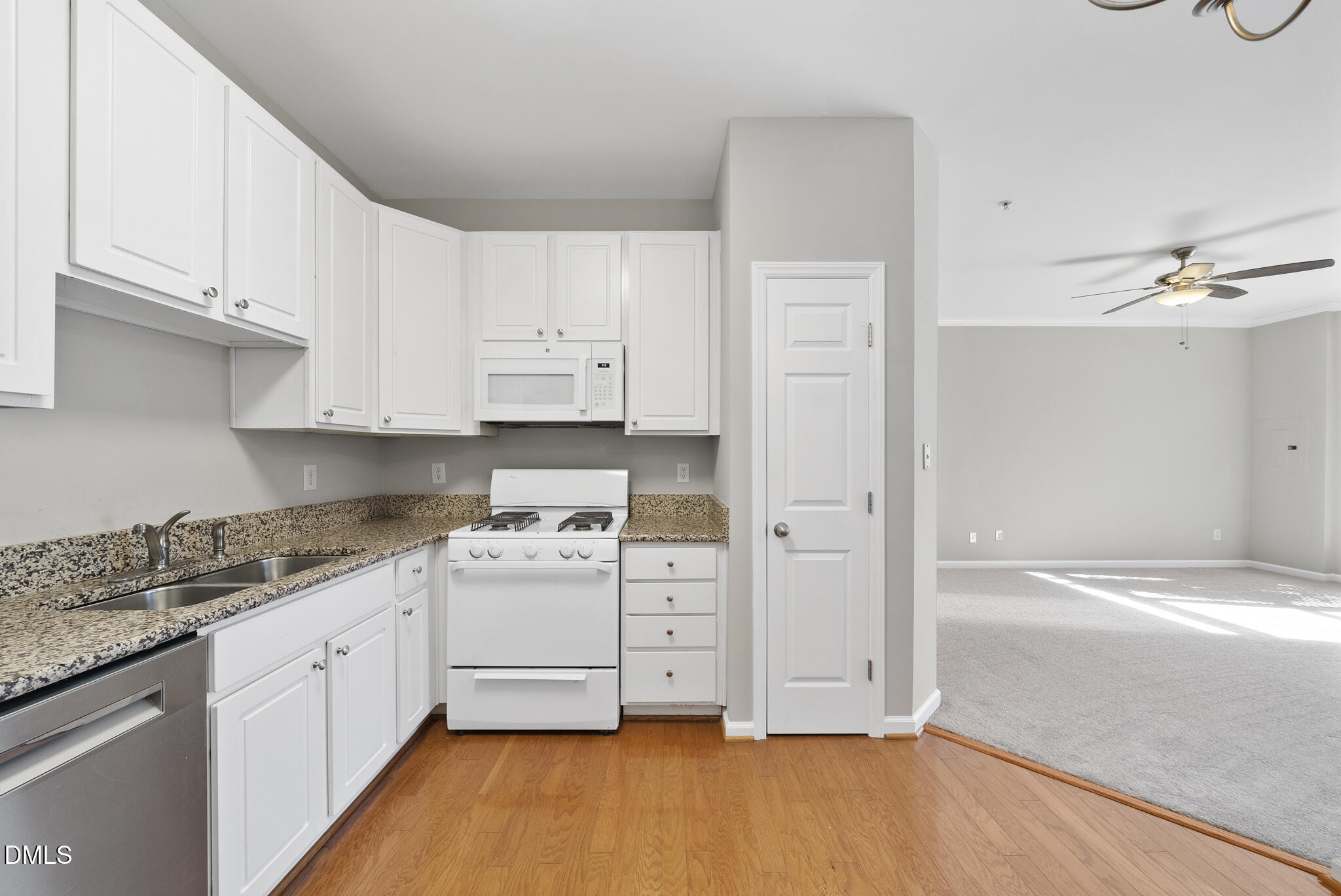 2211 Raven Road, Unit 102 Raleigh, NC 27614 - Photo 9 of 30 a kitchen with white cabinets and white appliances