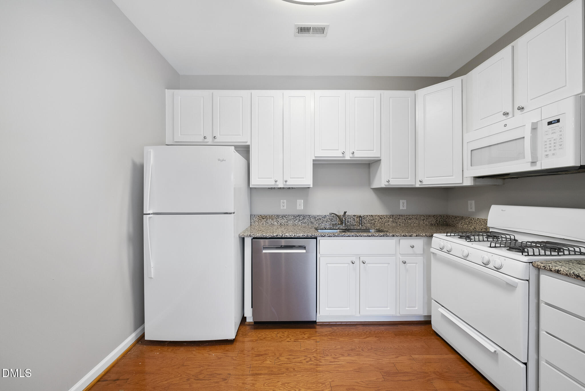 2211 Raven Road, Unit 102 Raleigh, NC 27614 - Photo 11 of 30 a kitchen with granite countertop white cabinets and white appliances