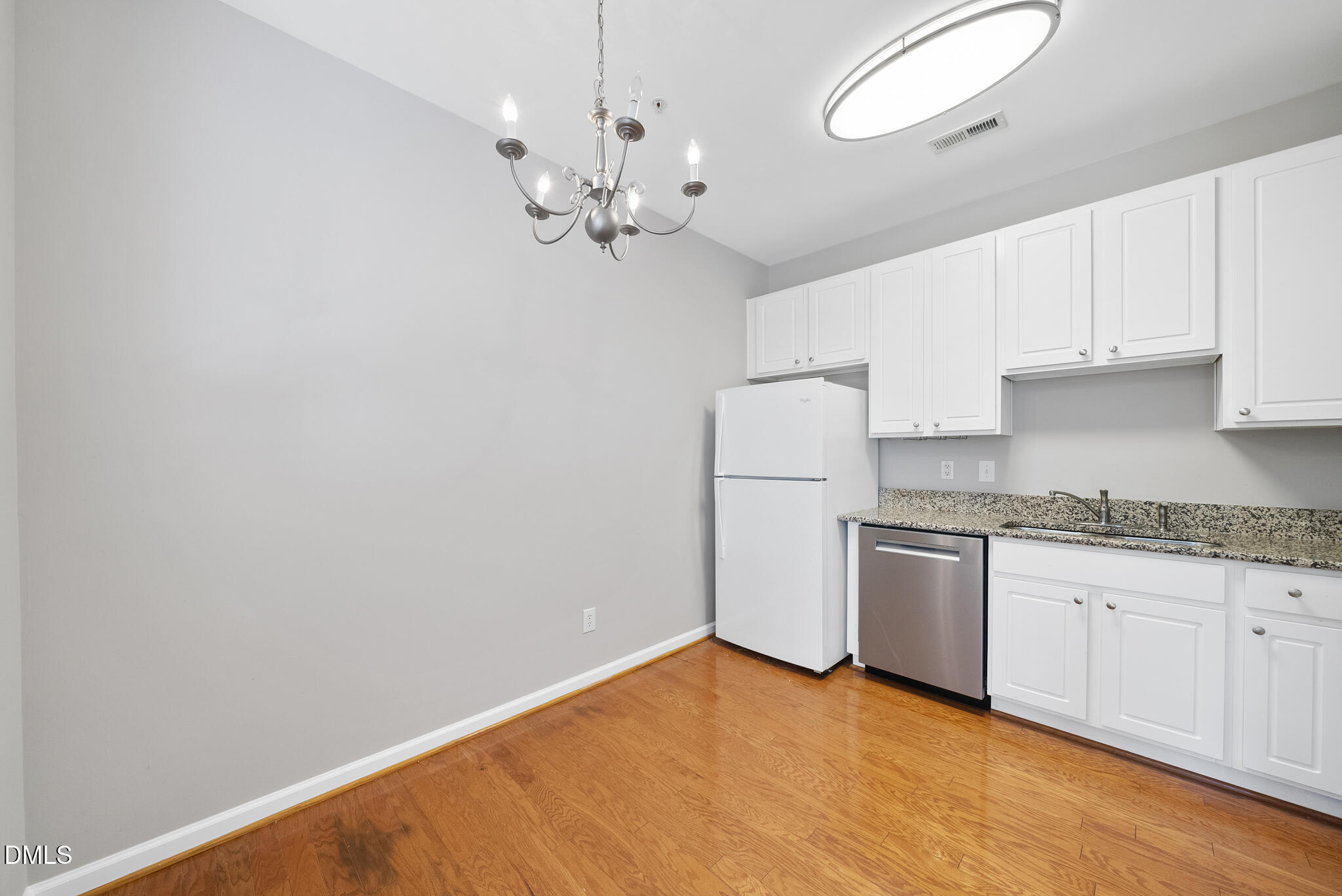 2211 Raven Road, Unit 102 Raleigh, NC 27614 - Photo 12 of 30 a kitchen with granite countertop cabinets a sink a stove and refrigerator