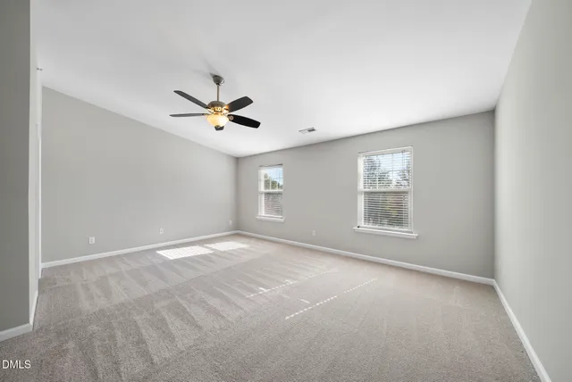 a kitchen with stainless steel appliances granite countertop a stove a sink and white cabinets with wooden floor