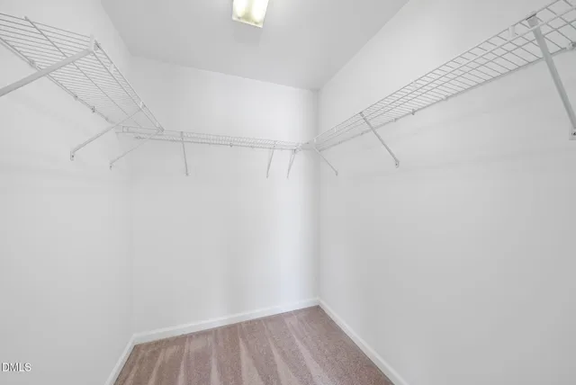 a kitchen with granite countertop cabinets a sink a stove and refrigerator