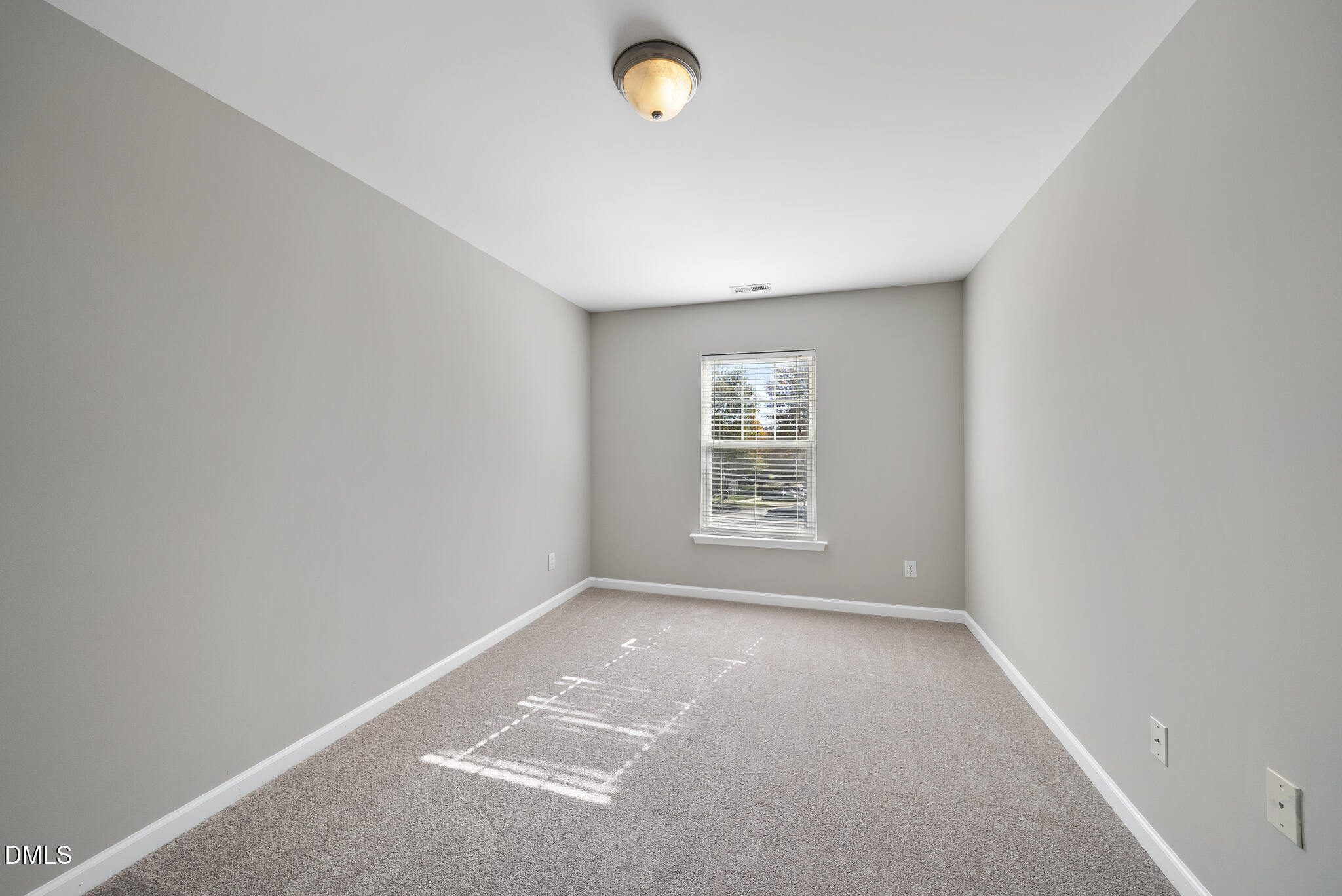 2211 Raven Road, Unit 102 Raleigh, NC 27614 - Photo 21 of 30 an empty room with a chair and a window
