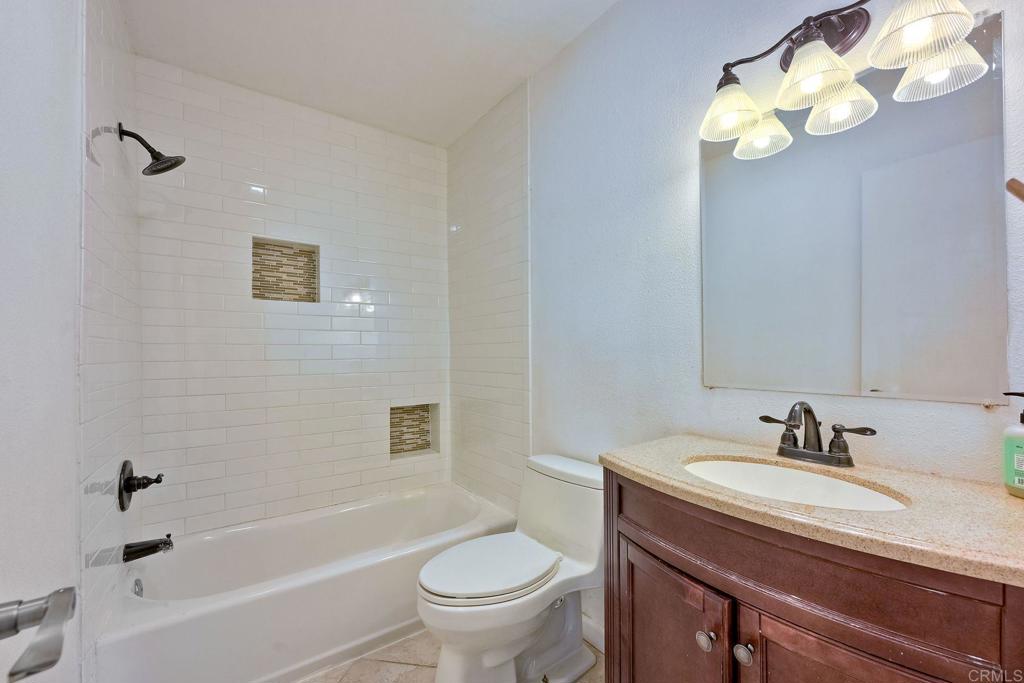 8741 Wahl Street Santee, CA 92071 - Photo 16 of 30 a bathroom with a sink a toilet and a bathtub