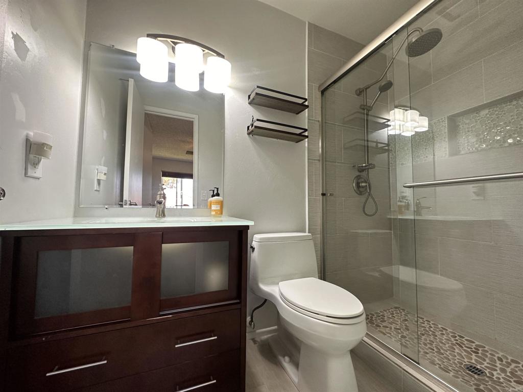 8741 Wahl Street Santee, CA 92071 - Photo 20 of 30 a bathroom with a sink a toilet and shower