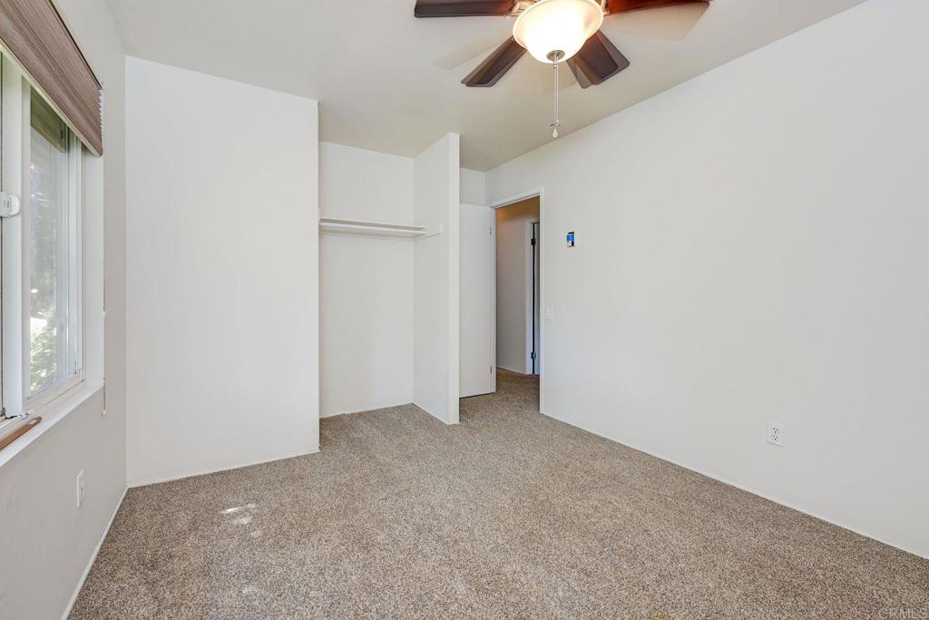 8741 Wahl Street Santee, CA 92071 - Photo 22 of 30 an empty room with a ceiling fan and a window
