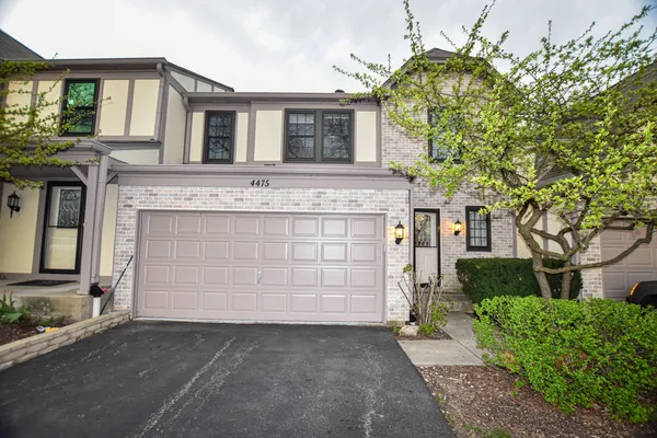 a front view of a house with a garage