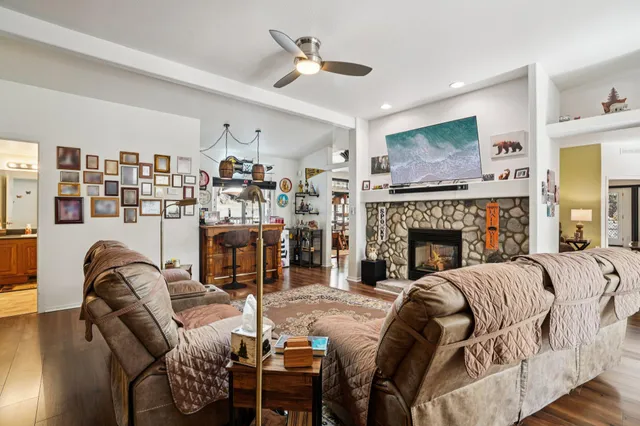 a living room with furniture and a wooden floor