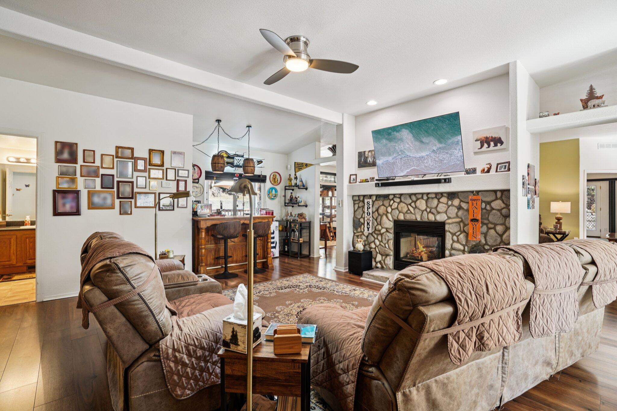 25001 Rim Rock Road Idyllwild, CA 92549 - Photo 11 of 49 a living room with furniture a flat screen tv and a fireplace