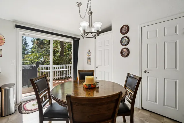 a view of a dining room with furniture and chandelier