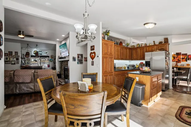 a kitchen with stainless steel appliances granite countertop sink stove and white cabinets with wooden floor