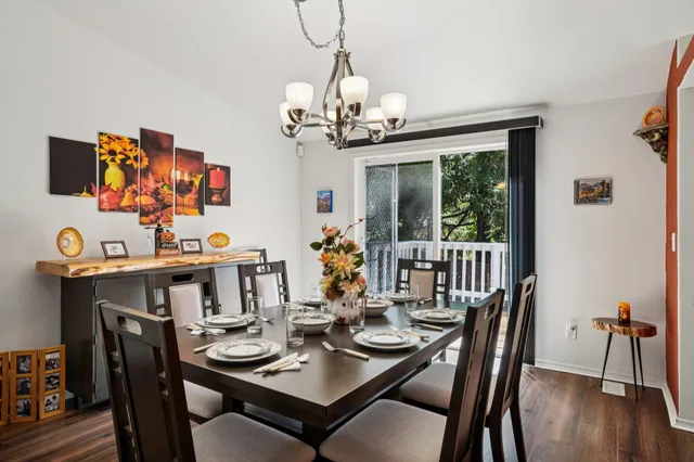 a dining room with furniture a chandelier and window